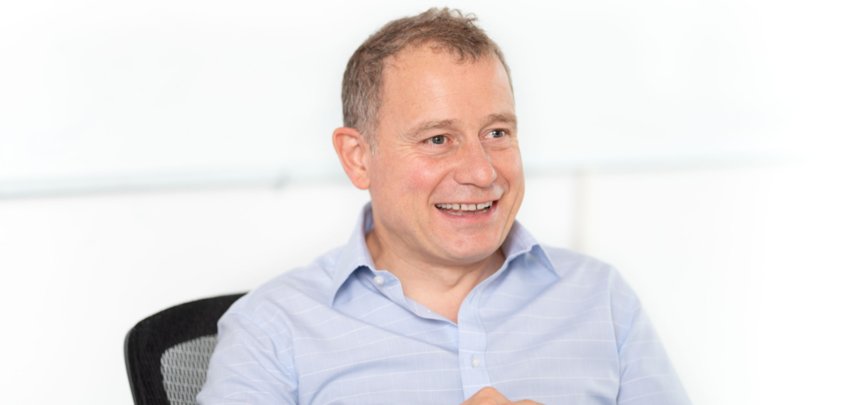 A person in a light blue shirt smiling